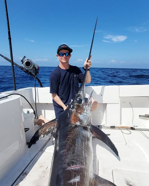 Tim with a swordfish on the boat