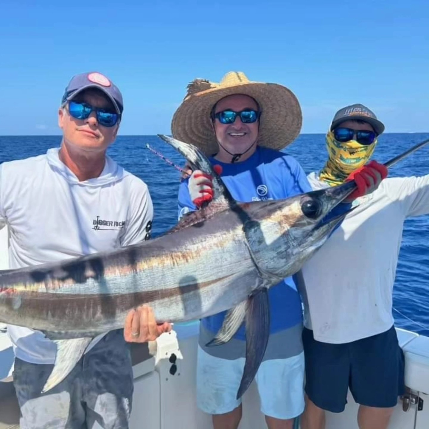 Tim with clients and a swordfish on a guided trip